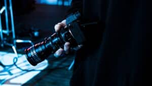 Meilleurs appareils photo numériques 2025 : main tenant un appareil photo professionnel avec objectif.