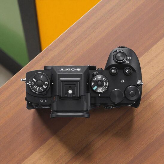 Sony A1 II camera top view. Professional full-frame mirrorless camera, showing dials and controls. High-resolution photography equipment.