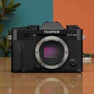 Fujifilm X-T30 III face. Black mirrorless camera with silver lens mount for photography enthusiasts.